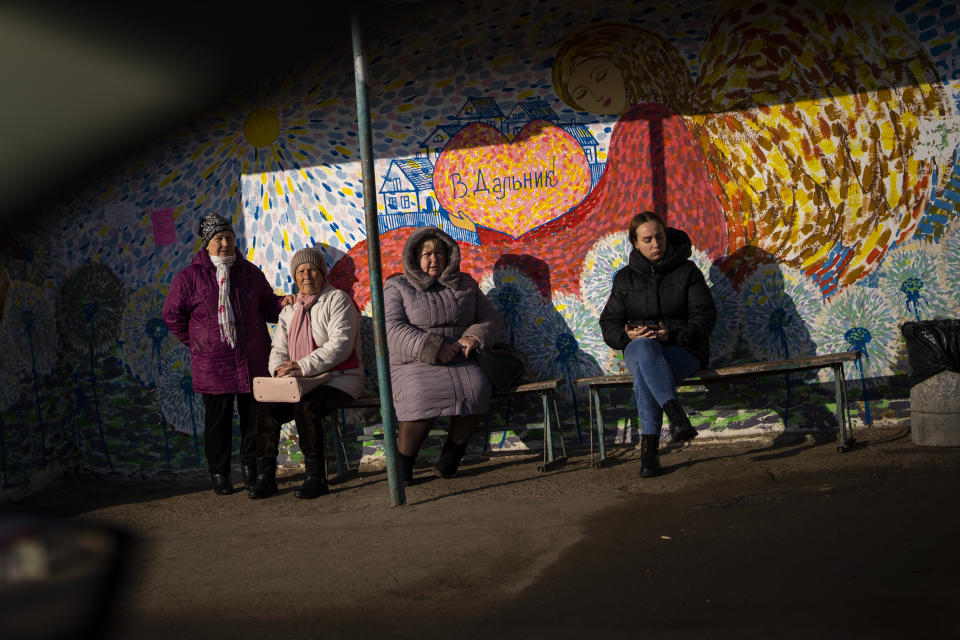 Women wait at a bus stop in Odessa, Ukraine, Thursday, Feb. 17, 2022. (AP Photo/Emilio Morenatti)