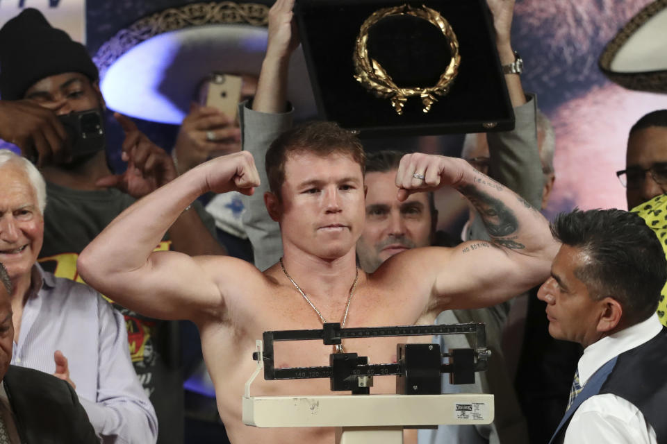 Boxer Saul "Canelo" Alvarez of Mexico poses on the scale during his weigh-in ceremony in Guadalajara, Mexico, Friday, May 5, 2023. Alvarez will face John Ryder of Britain for a super middleweight championship fight at Akron Stadium on May 6. (AP Photo/Refugio Ruiz)