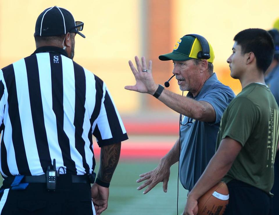 Sonora Head Coach Bryan Craig talks with an official during a game between Oakdale High School and Sonora High School at Oakdale High School in Oakdale California CA on August 18, 2023.