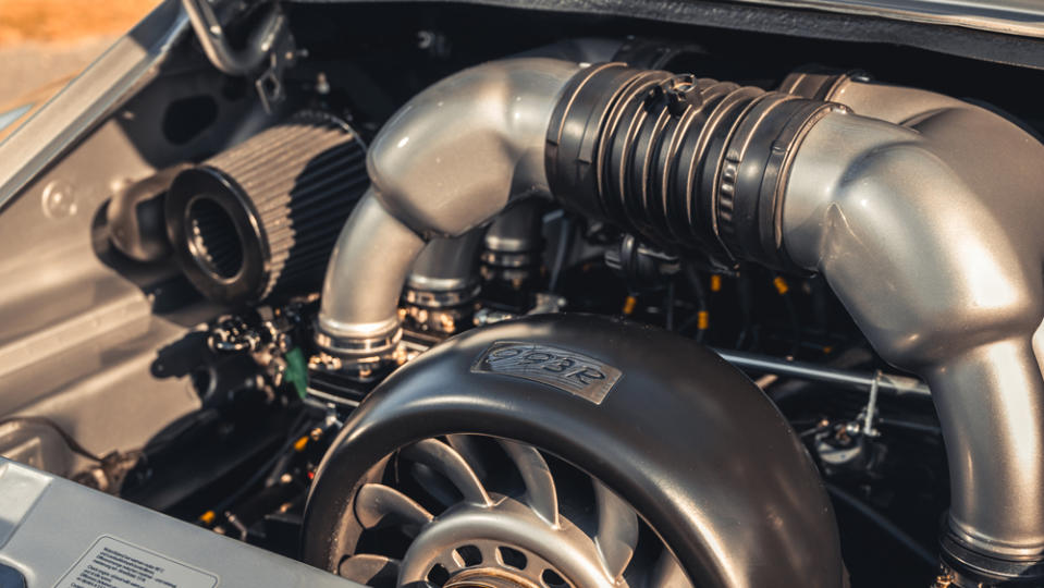 The 3.8-liter flat-six features a polished 996 GT3 plenum, individual throttle bodies and a 993R-branded shroud for the fan. - Credit: Courtesy of Paul Stephens.