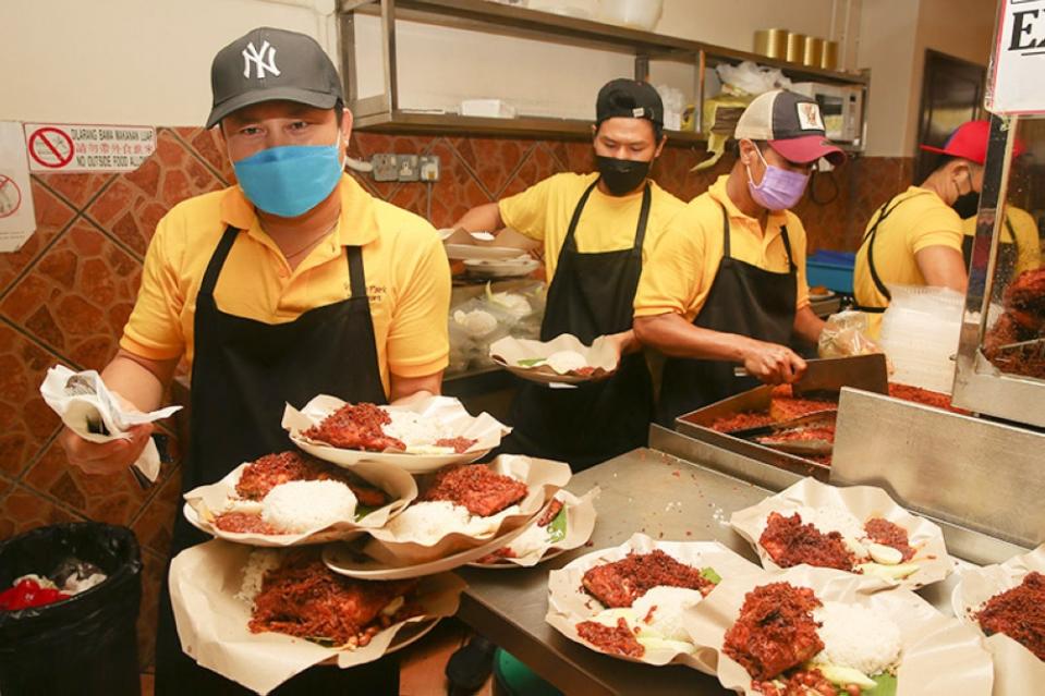 It's a mad rush to get plates of 'nasi lemak' to diners