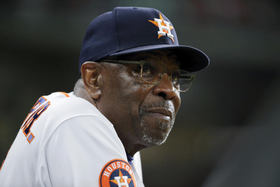 FILE - Houston Astros manager Dusty Baker Jr. checks the scoreboard from the dugout during a baseball game against the Seattle Mariners, July 6, 2023, in Houston. Longtime manager Baker would bet that anxiety in the air shortened more than a few careers. He recalls watching teammates and coaches cling tightly to photos of their loved ones during bumpy flights. (AP Photo/Michael Wyke, File)