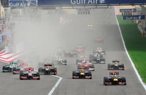 Red Bull Racing's German driver Sebastian Vettel leads (R) after the start at the Bahrain international circuit in Manama during the Bahrain Formula One Grand Prix. Bahrain's controversial Grand Prix race went off without incident on Sunday after a week of angry protests away from the F1 desert circuit that put the non-sporting focus on reform demands in the Gulf state