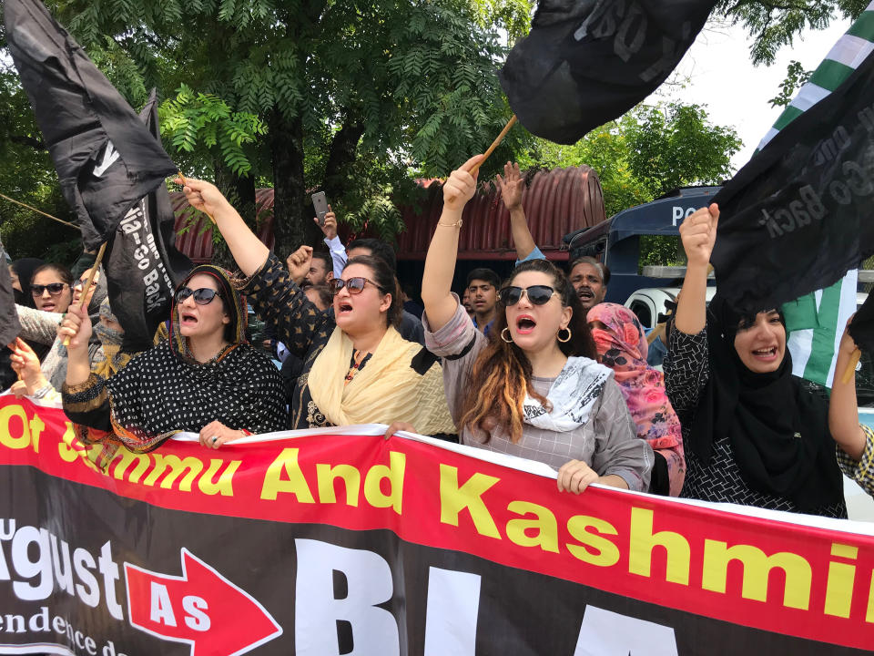 Pakistani Kashmiris observe Black Day on the occasion of India's Independence Day near Indian High Commission in Islamabad, Pakistan, Thursday, Aug. 15, 2019. Pakistan's prime minister has questioned the silence of world community over recent change in the status of Indian-administered sector of Kashmir by New Delhi and lingering imposition of security clampdown which deprived Kashmiri people of their basic rights. (AP Photo/B.K. Bangash)