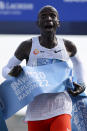 Kenya's Eliud Kipchoge crosses the line to win the Berlin Marathon in Berlin, Germany, Sunday, Sept. 25, 2022. Olympic champion Eliud Kipchoge has bettered his own world record in the Berlin Marathon. Kipchoge clocked 2:01:09 on Sunday to shave 30 seconds off his previous best-mark of 2:01:39 from the same course in 2018. (AP Photo/Christoph Soeder)