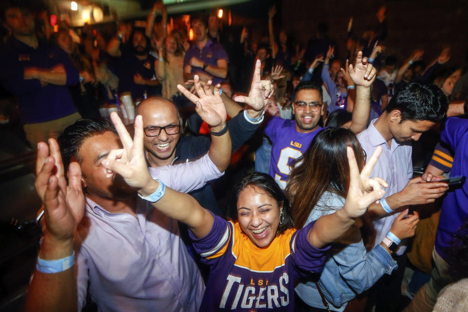 LSU fans celebrate at Varsity Theatre, in Baton Rouge, La., after LSU defeated Clemson 42-25 in the NCAA College Football Playoff championship game, Monday, Jan. 13, 2020. (AP Photo/Brett Duke)