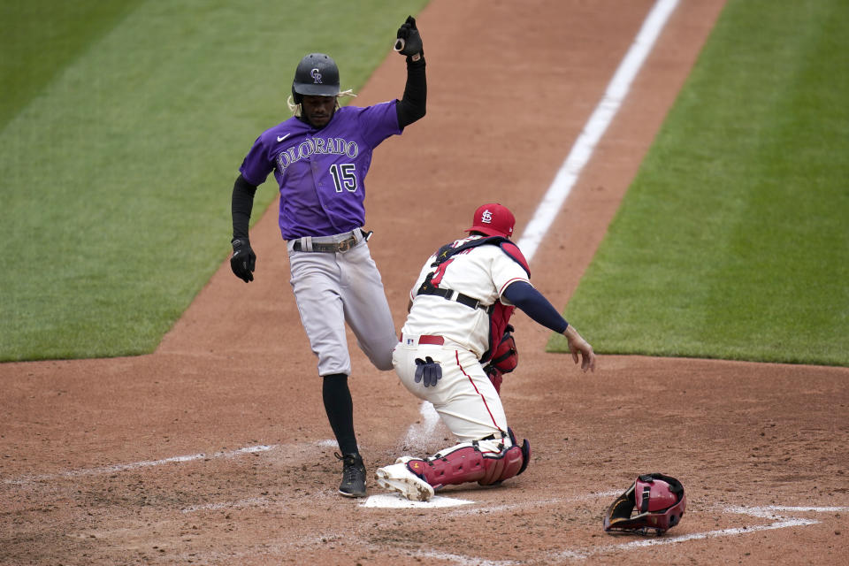 Colorado Rockies' Raimel Tapia (15) is forced out as St. Louis Cardinals catcher Yadier Molina covers home during the fifth inning of a baseball game Saturday, May 8, 2021, in St. Louis. (AP Photo/Jeff Roberson)