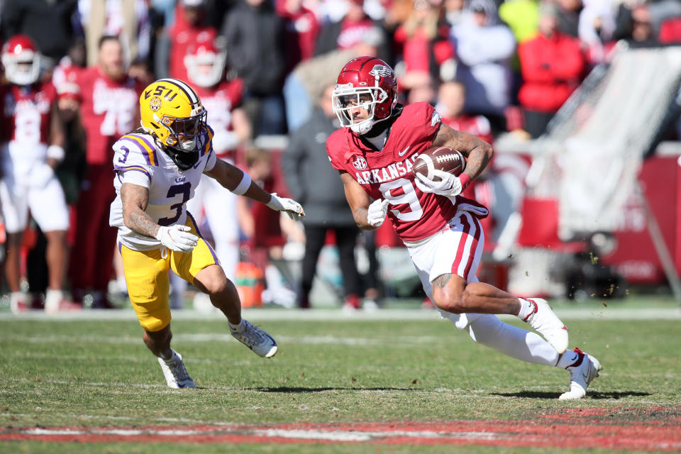Nov 12, 2022; Fayetteville, Arkansas, USA; Arkansas Razorbacks wide receiver <a class="link " href="https://sports.yahoo.com/nfl/players/40515" data-i13n="sec:content-canvas;subsec:anchor_text;elm:context_link" data-ylk="slk:Jadon Haselwood;sec:content-canvas;subsec:anchor_text;elm:context_link;itc:0">Jadon Haselwood</a> (9) runs after a catch int he first quarter as LSU Tigers safety Greg Brooks Jr (3) defends at Donald W. Reynolds Razorback Stadium. Mandatory Credit: Nelson Chenault-USA TODAY Sports