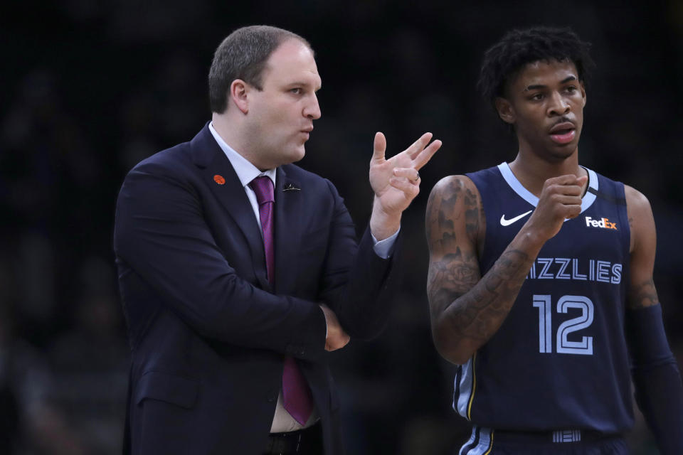 Memphis Grizzlies head coach Taylor Jenkins, left, talks with Memphis Grizzlies guard Ja Morant (12) during a time out in the first half of an NBA basketball game in Boston, Wednesday, Jan. 22, 2020. (AP Photo/Charles Krupa)