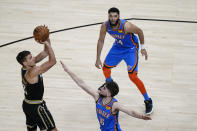 Atlanta Hawks guard Bogdan Bogdanovic (13) scores against Oklahoma City Thunder guard Ty Jerome (16) during the second half of an NBA basketball game on Thursday, March 18, 2021, in Atlanta. (AP Photo/Brynn Anderson)