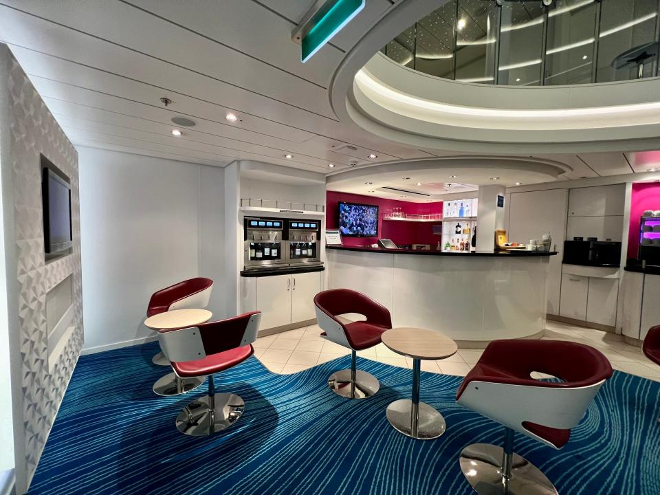 Norwegian Getaway studio lounge lower level (seats and tables, bar in the back, wine vending machine)