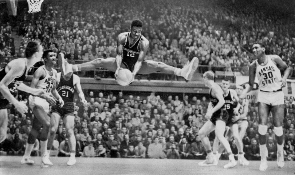 FILE - Cincinnati's Oscar Robertson (12) grabs a rebound against Kansas State during an NCAA college basketball regional elimination game in Manhattan, Kan., in March 1959. At far right is Kansas State's Bob Boozer (30). (AP Photo/File)