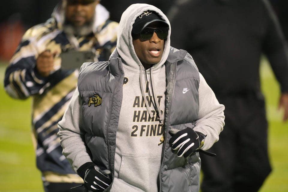 Colorado head coach Deion Sanders walks the perimeter of the field as players warm up for an NCAA college football game against Oregon State on Saturday, Nov. 4, 2023, in Boulder, Colo. (AP Photo/David Zalubowski)
