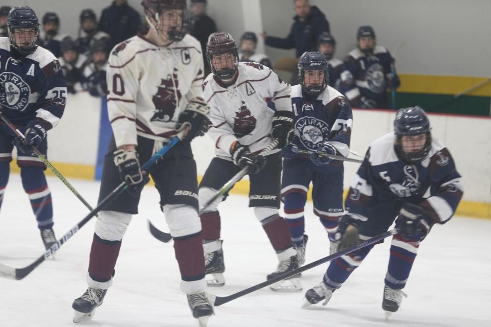 Portsmouth/Newmarket's Patrick Slover (10) and teammate Cal Rothstein look down the ice during Wednesday's Division II boys hockey game against Alvirne/Milford at Dover Ice Arena. Portsmouth/Newmarket lost 4-1 and fell to 3-8-1 on the season.