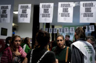 State workers, some who have been laid off, gather inside the National Institute against Discrimination, Xenophobia, and Racism in Buenos Aires, Argentina, Wednesday, April 3, 2024. According to the State Workers Association, more than 11 thousand dismissals of state employees have been carried out by Javier Milei’s government. The union is calling for massive and simultaneous re-entry of dismissed individuals. (AP Photo/Natacha Pisarenko)