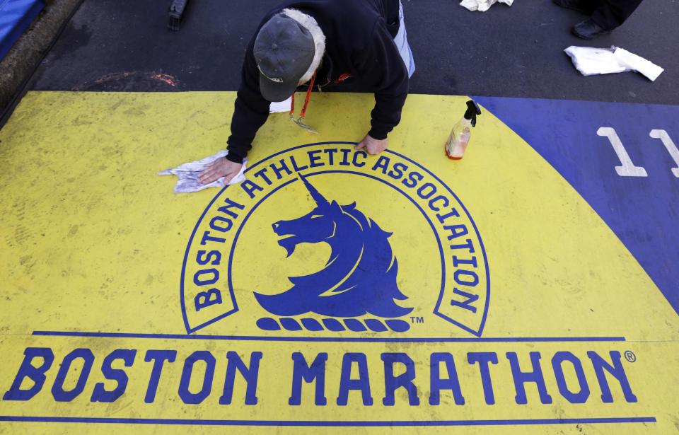 Pepi Bolognese cleans the finish line before the running of the 118th Boston Marathon Monday, April 21, 2014 in Boston. (AP Photo/Robert F. Bukaty)