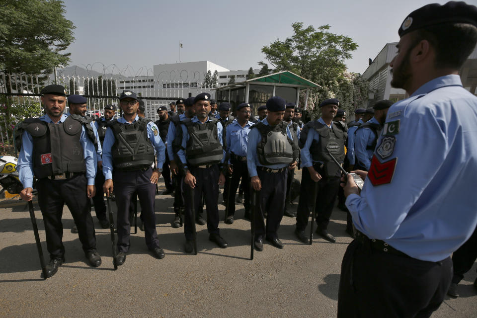 Police officers stand guard to ensure security outside the National Assembly in Islamabad, Pakistan, Saturday, April 9, 2022. Pakistan's embattled prime minister faces a tough no-confidence vote Saturday waged by his political opposition, which says it has the numbers to defeat him. (AP Photo/Anjum Naveed)