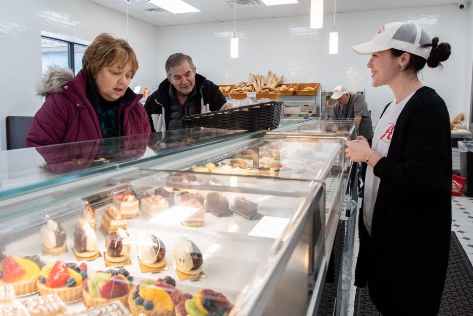 Maria Guarini, right, head barista at Alto Bakery & Caffè in Warminster, helps customers, Joanne Ramer and Dave Frankenfield, of Warminster, as they pick out desserts on Tuesday, January 23, 2024.