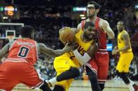 May 6, 2015; Cleveland, OH, USA; Cleveland Cavaliers guard Kyrie Irving (2) drives through Chicago Bulls guard Aaron Brooks (0) and guard Kirk Hinrich (12) during the fourth quarter in game two of the second round of the NBA Playoffs at Quicken Loans Arena. Mandatory Credit: Ken Blaze-USA TODAY Sports