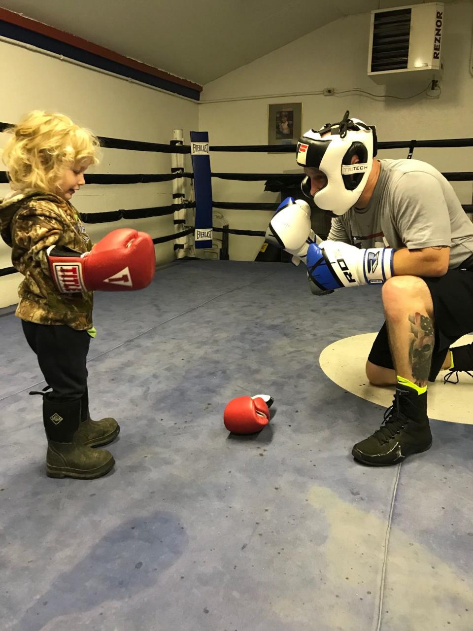 Jeremy Marchek giving Maveric Desander some boxing lessons at the Clinton County Boxing Club.