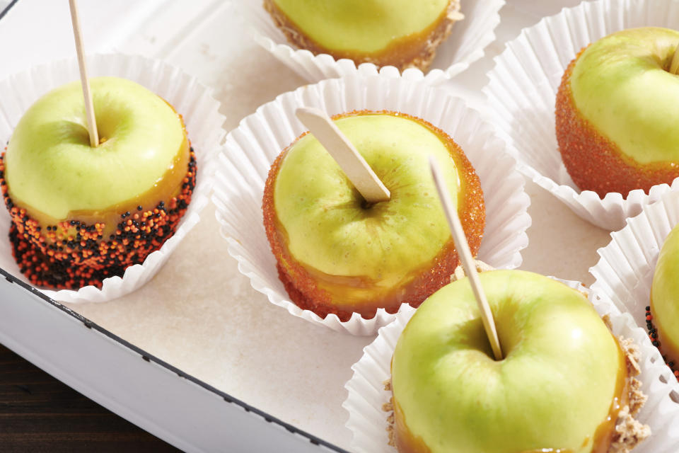Caramel apples are displayed in New York in October 2020. Homemade caramel apples are surprisingly easy to make. You can use whatever apples you like, as long as they are firm and crisp (Cheyenne M. Cohen via AP)