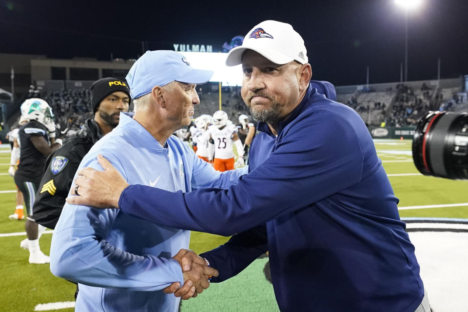 Tulane head coach Willie Fritz, left, greets, UTSA head coach Jeff Traylor after an NCAA college football game in New Orleans, Friday, Nov. 24, 2023. Tulane won 29-16. (AP Photo/Gerald Herbert)