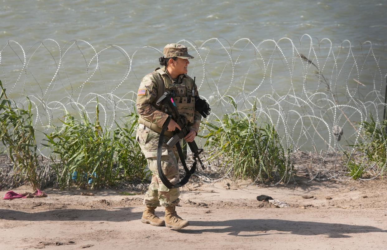 A Texas National Guard soldier patrols the banks of the Rio Grande in Eagle Pass. The Texas National Guard and the U.S. Border Patrol have been at odds over access to parts of the border in Texas.