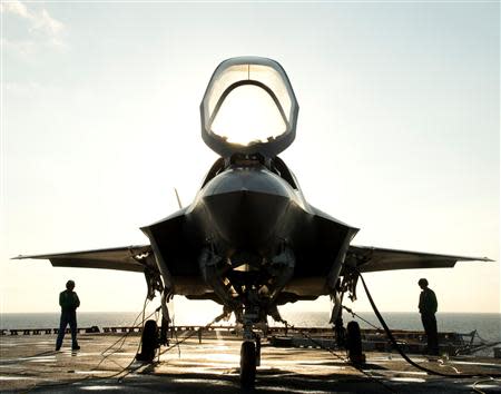 The flight deck crew secures an F-35B Lighting II aircraft aboard the amphibious assault ship USS Wasp following testing in this handout photo taken off the coast of North Carolina in this August 24, 2013 file photo. REUTERS/U.S. Navy/Handout