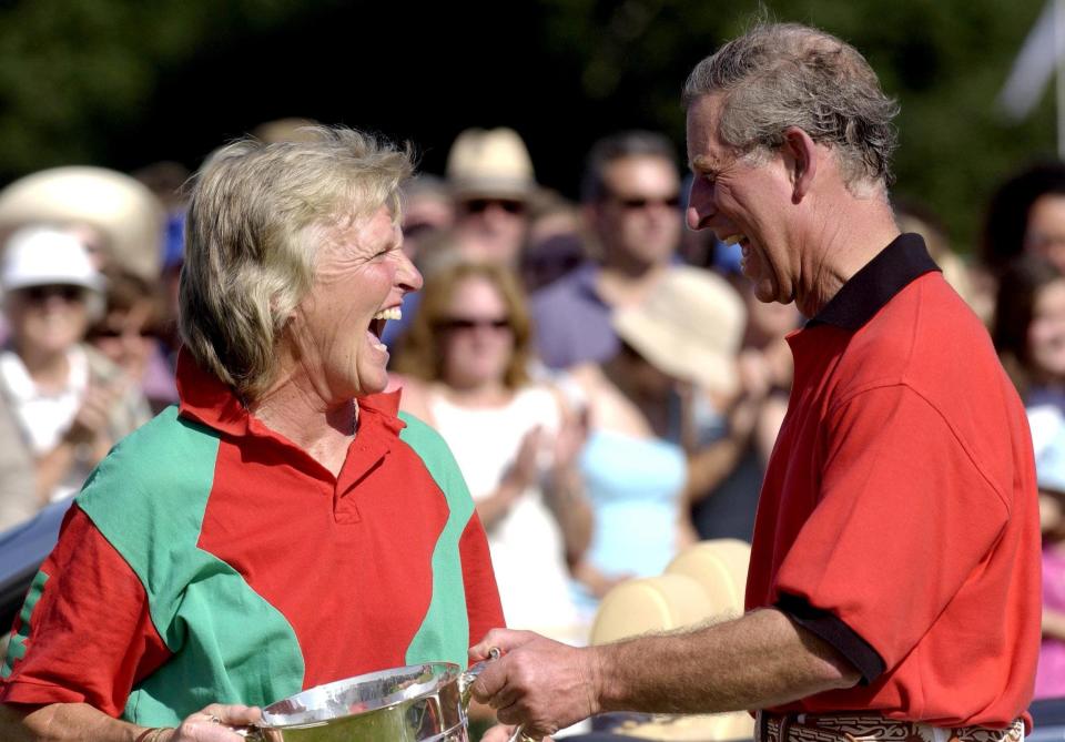 Claire Tomlinson receiving the Cowdray Park Challenge Cup Trophy from the Prince of Wales at the Princes Trust charity polo match at Cowdray Park, West Sussex, in 2003 - David Hartley/Shutterstock 