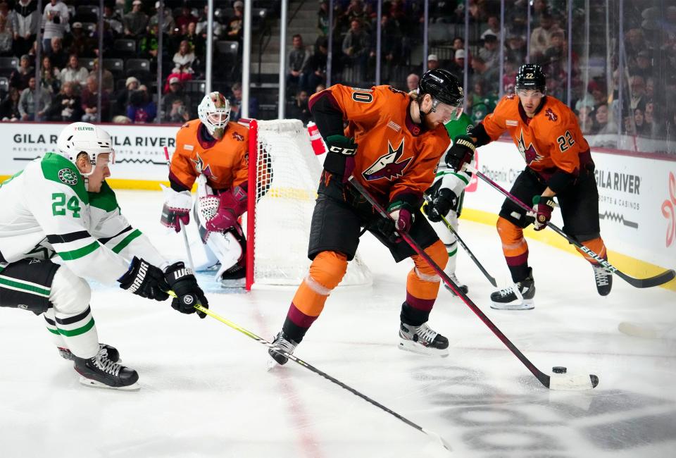 Nov 3, 2022; Tempe, AZ, USA; Arizona Coyotes defenseman J.J. Moser (90) is pressured by Dallas Stars center Roope Hintz (24) in the first period at Mullett Arena. Mandatory Credit: Rob Schumacher-Arizona Republic