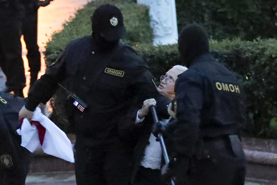 Police detain an elderly woman during a Belarusian opposition supporters rally at Independence Square in Minsk, Belarus, Wednesday, Aug. 26, 2020. Protests demanding the resignation of Belarus' authoritarian President Alexander Lukashenko have entered their 18th straight day on Wednesday. (AP Photo/Sergei Grits)