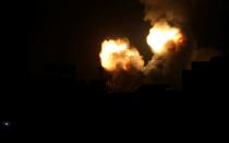 Flame and smoke are seen during Israeli air strikes in the southern Gaza Strip
