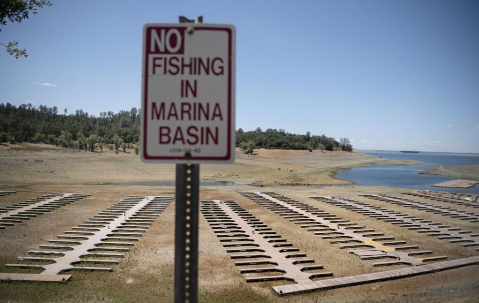 FILE – Empty boat dock sit on dry land at the Browns Ravine Cove area of drought-stricken Folsom Lake in Folsom, Calif., on May 22, 2021. Months of winter storms have replenished California’s key reservoirs after three years of punishing drought. (AP Photo/Josh Edelson, File)