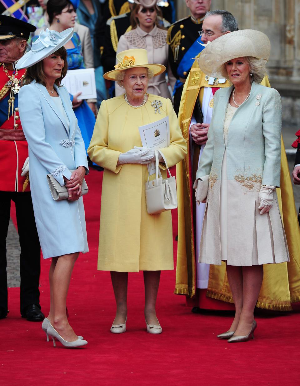 Carole blending tonally with the Queen in lemon and the Duchess of Cornwall in mint - Credit: Rex