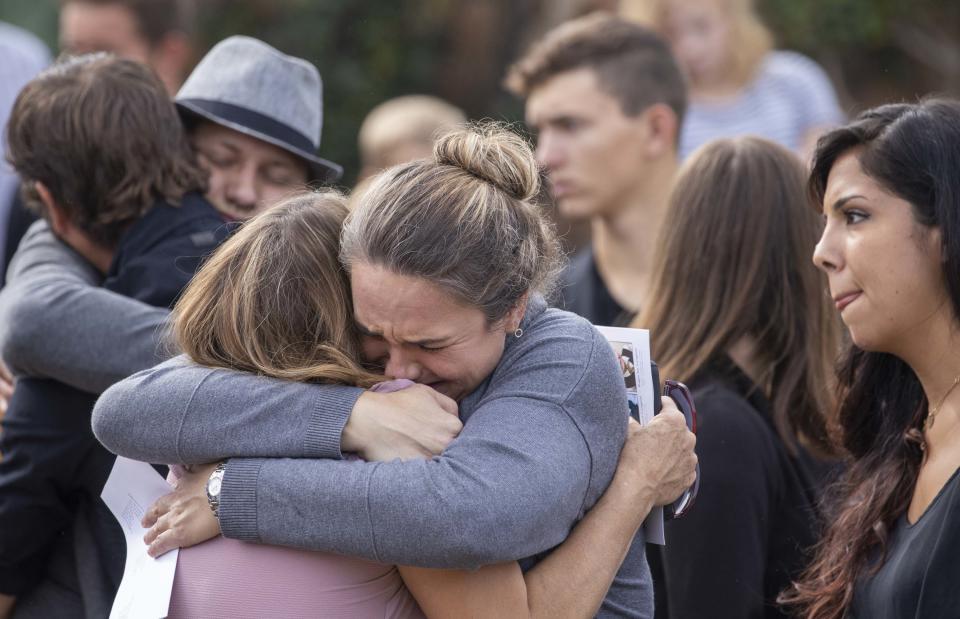 Family members and friends console each other while they attend the funeral for Dawna Ray Langford and her two children Trevor, 9, and Rogan, 7, on Nov. 7, 2019.