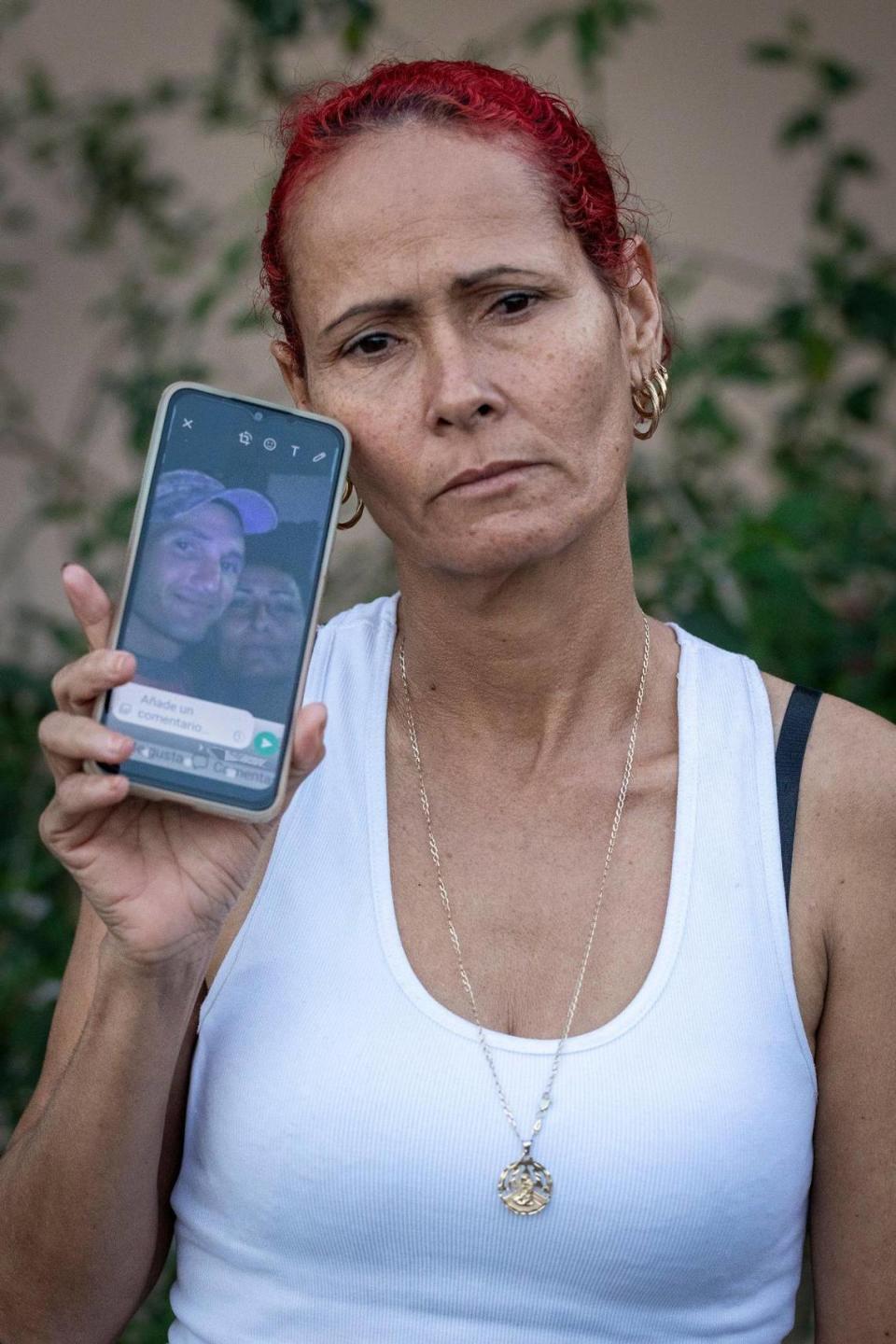Luisa Yanes Perez, a recently arrived Cuban woman who came by boat 3 months ago, holds her cellphone with a picture of her missing sister Edelmira, and her husband Yurisnel. In late December, Edelmira and Yurisnel along with others attempted to cross the Florida Straits the same way Luisa did, but they have not been heard from since.