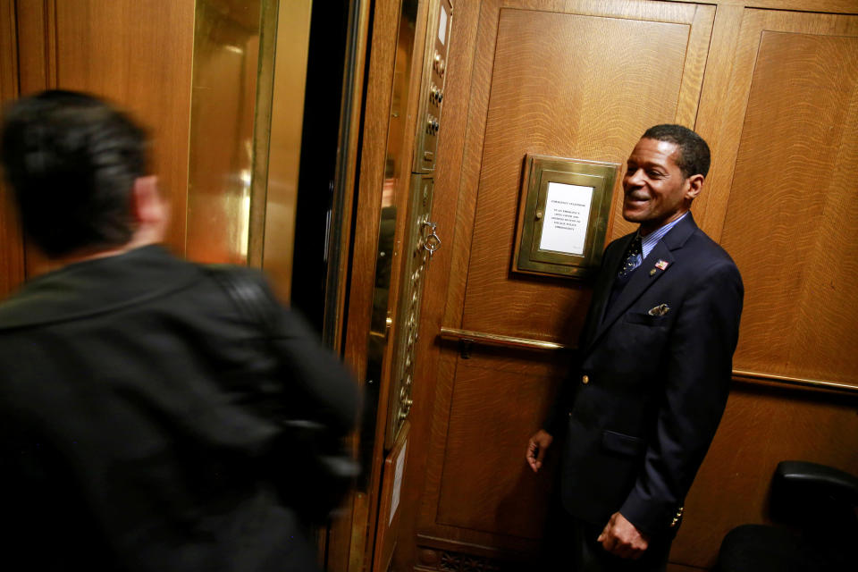 Elevator operator Johnnie Bacon, from Washington, smiles at a passenger as he tends one of the elevators in the U.S. Supreme Court building in Washington, U.S. April 4, 2016.&nbsp;