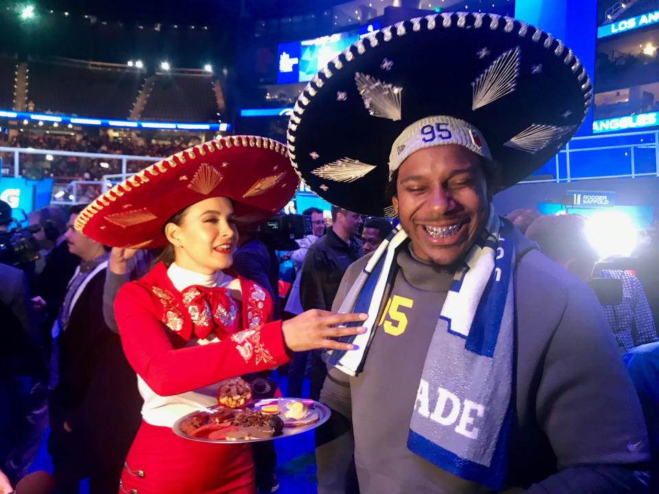 Los Angeles Rams defensive end Ethan Westbrooks tries a dried cricket at Super Bowl opening night. (Reuters)