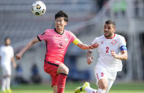 South Korea's Son Heung-min, left, fights for the ball against Lebanon's Kassem El Zein during their Asian zone Group H qualifying soccer match for the FIFA World Cup Qatar 2022 at Goyang stadium in Goyang, South Korea, Sunday, June 13, 2021. (AP Photo/Lee Jin-man)
