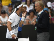 Italy's Fabio Fognini gestures as he talks with Grand Slam supervisor Gerry Armstrong during his fourth round singles match against Tennys Sandgren of the U.S. at the Australian Open tennis championship in Melbourne, Australia, Sunday, Jan. 26, 2020. (AP Photo/Andy Brownbill)
