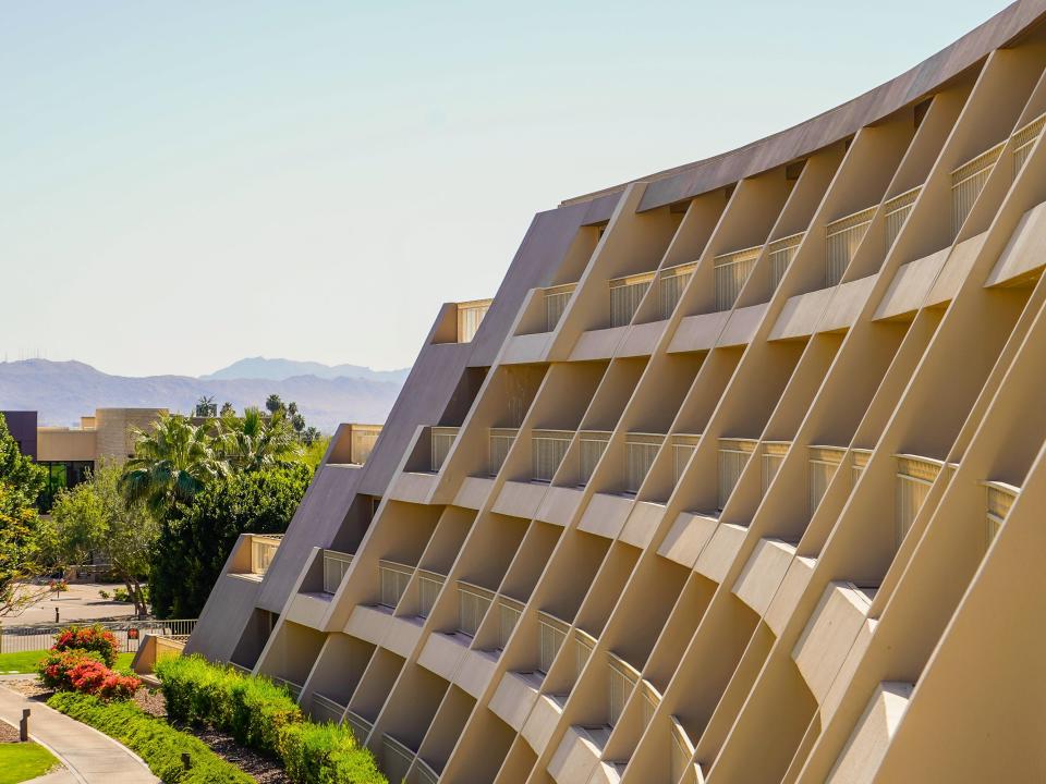 A geometric beige building in Scottsdale with mountains in the background