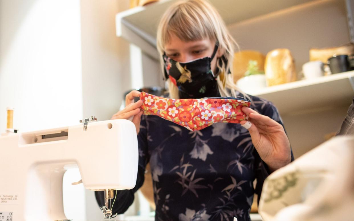 Germany Small fashion business sews sustainable face masks  -  PHILIPP GUELLAND/Shutterstock