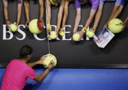 Rafael Nadal of Spain signs autographs after defeating Tim Smyczek of the U.S. in their men's singles second round match at the Australian Open 2015 tennis tournament in Melbourne January 21, 2015. REUTERS/Thomas Peter (AUSTRALIA - Tags: SPORT TENNIS)