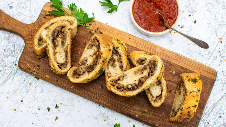 Mushroom and Walnut Stromboli on wooden board