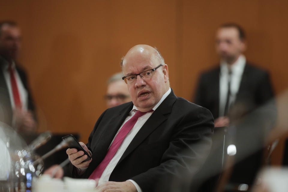 German Economy Minister Peter Altmaier makes a phone call prior to the weekly cabinet meeting of the German government at the chancellery in Berlin, Germany, Wednesday, April 8, 2020. In order to slow down the spread of the coronavirus, the German government has considerably restricted public life and asked the citizens to stay at home. The new coronavirus causes mild or moderate symptoms for most people, but for some, especially older adults and people with existing health problems, it can cause more severe illness or death.(AP Photo/Markus Schreiber, Pool)