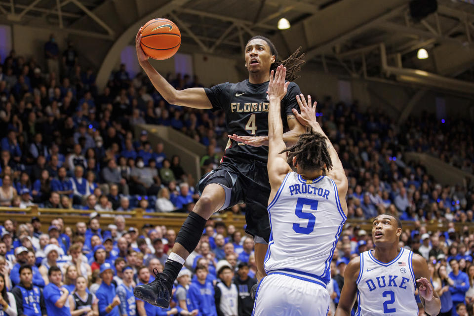 Florida State's Caleb Mills (4) attempts a shot as Duke's Tyrese Proctor (5) and Jaylen Blakes (2) defend during the first half of an NCAA college basketball game in Durham, N.C., Saturday, Dec. 31, 2022. (AP Photo/Ben McKeown)