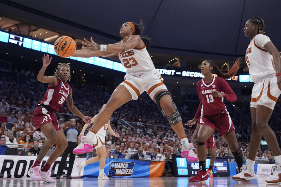 Texas forward Aaliyah Moore (23) grabs a rebound in front of Alabama guard Del’Janae Williams (51) during the first half of a second-round college basketball game in the women’s NCAA Tournament in Austin, Texas, Sunday, March 24, 2024. (AP Photo/Eric Gay)