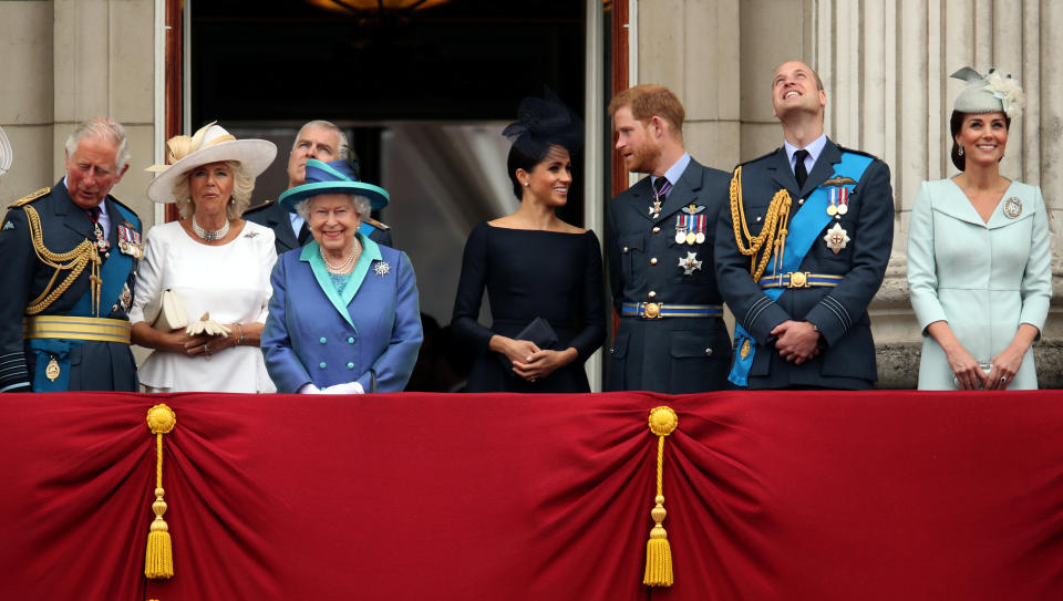 Britain's Prince Charles, Camilla, Duchess of Cornwall, Queen Elizabeth, Meghan, Duchess of Sussex, Prince Harry, Prince William, and Catherine, Duchess of Cambridge stand on the balcony of Buckingham Palace as they watch a fly past to mark the centenary of the Royal Air Force in central London, Britain July 10, 2018. REUTERS/Chris Radburn