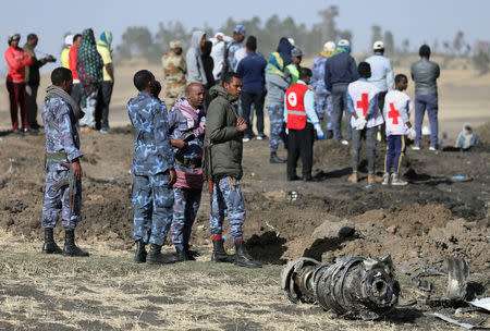 FILE PHOTO - Ethiopian Federal policemen stand near engine parts at the scene of the Ethiopian Airlines Flight ET 302 plane crash, near the town of Bishoftu, southeast of Addis Ababa, Ethiopia March 11, 2019. REUTERS/Tiksa Negeri