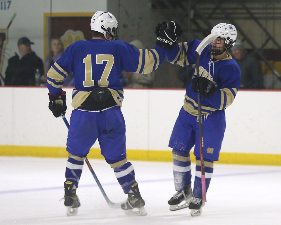 Norwell's Nolan Petrucelli celebrates his short handed goal with Norwell's Matt Cerruti to give Norwell the 4-2 lead over Cohasset/ Hull during second period action of their game against Cohasset/ Hull at Connell Rink and Pool in Weymouth on Saturday, Jan. 21, 2023. 